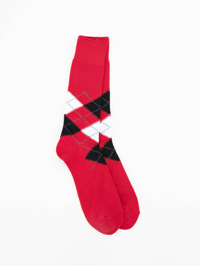 A pair of red crew socks with an argyle pattern in black, white, and gray, displayed against a plain white background.