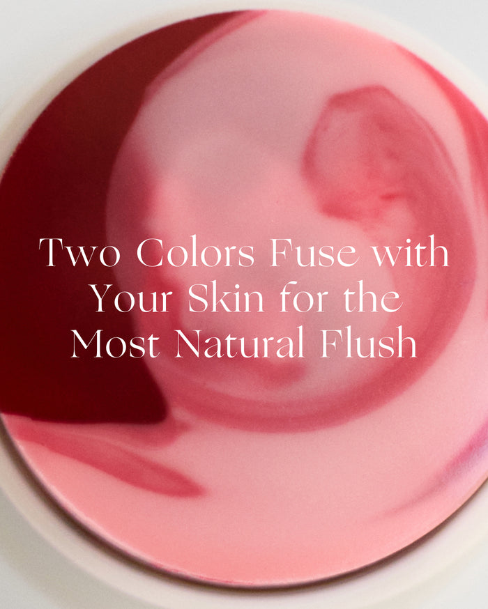 Two Colors Fuse with Your Skin for the Most Natural Flush. Close-up of a circular cosmetic product with swirled deep berry red and soft pink shades in a creamy texture.