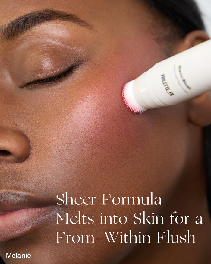 A model with deep skin tone applies Violette_FR Blush, creating a rosy-pink flush. Text on the product reads 'Blush VIOLETTE_FR'. Overlaid text: 'Sheer Formula Melts into Skin for a From-Within Flush Mélanie'.