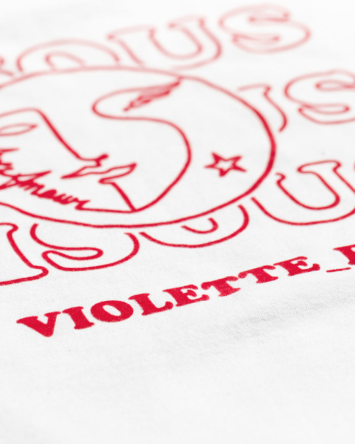 White fabric with red print featuring a stylized sun/moon face and the text 'TOUS L'AMOUR VIOLETTE_FR'.
