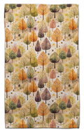 Eco-friendly towel featuring an all-over autumn forest pattern with trees in shades of orange, yellow, green, and brown on a cream background.