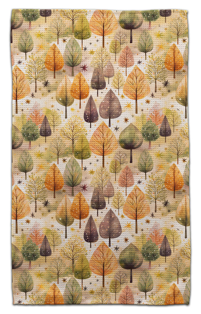 Eco-friendly towel featuring an all-over autumn forest pattern with trees in shades of orange, yellow, green, and brown on a cream background.