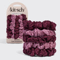A set of five Kit-Sch ruched lace scrunchies in a vertical color gradient from light pink to deep burgundy, shown with the retail packaging on a light gray background.
