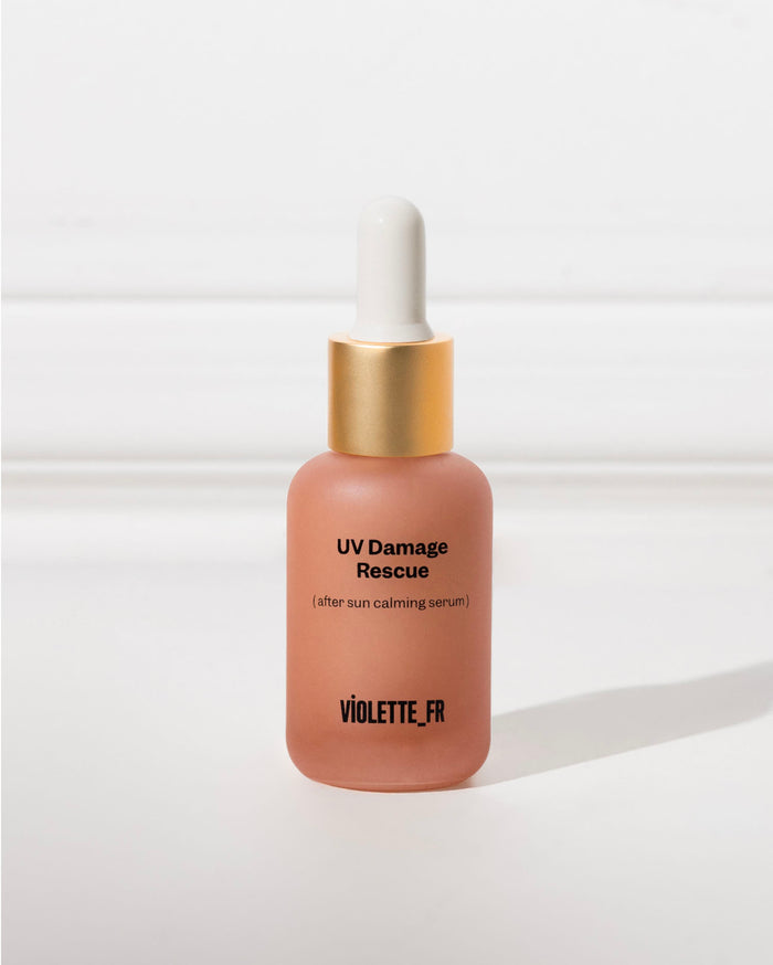 UV Damage Rescue (after sun calming serum) VIOLETTE_FR on a frosted peach dropper bottle with a gold collar and white top.