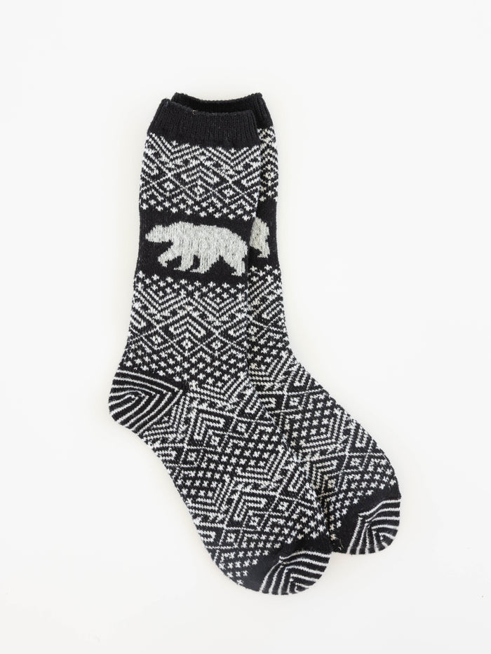 World's Softest black and white patterned crew sock with a white polar bear motif on the side, displayed against a plain white background.