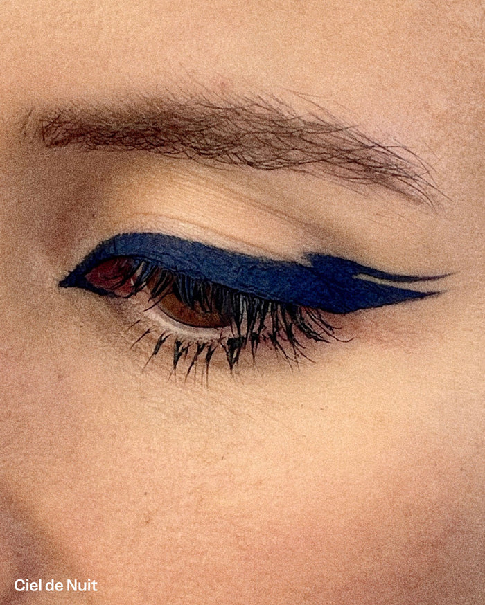 Ciel de Nuit eyeliner shade shown on a medium skin tone eye with a dark blue winged liner.