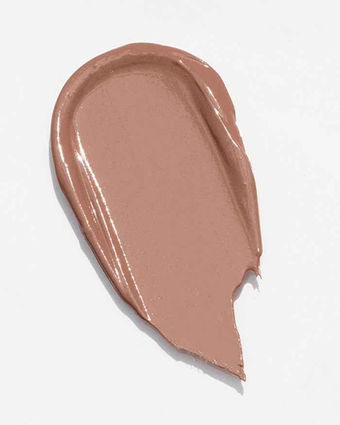 A swatch of creamy, warm medium-toned brown liquid product with a slightly glossy finish.